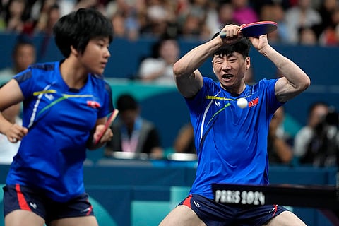 North Korea's Ri Jong Sik, right, and Kim Kum Yong play against China's Wang Chuqin and Sun Yingsha during mixed doubles final